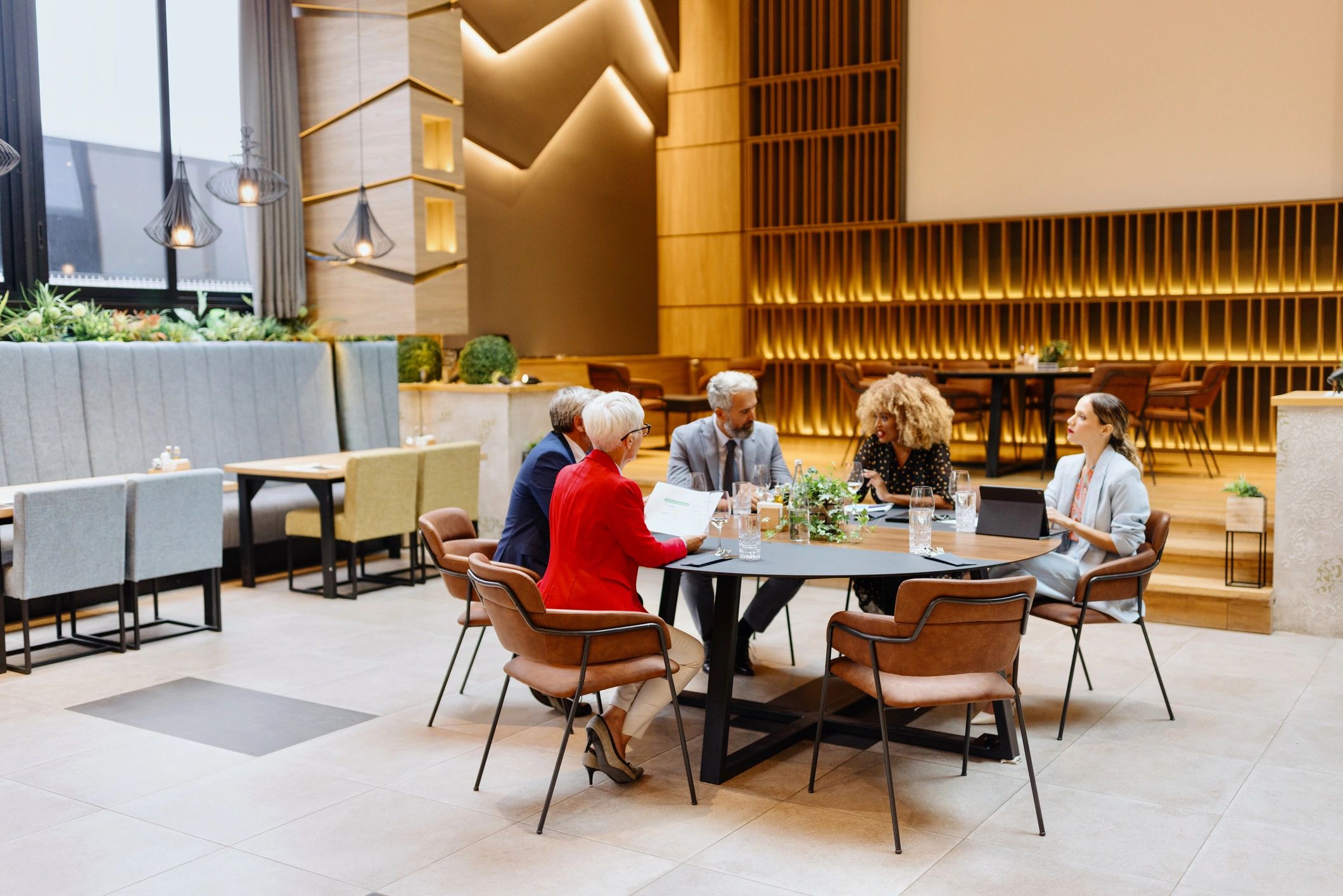 Business event guests gathered around a dining table at a premium venue