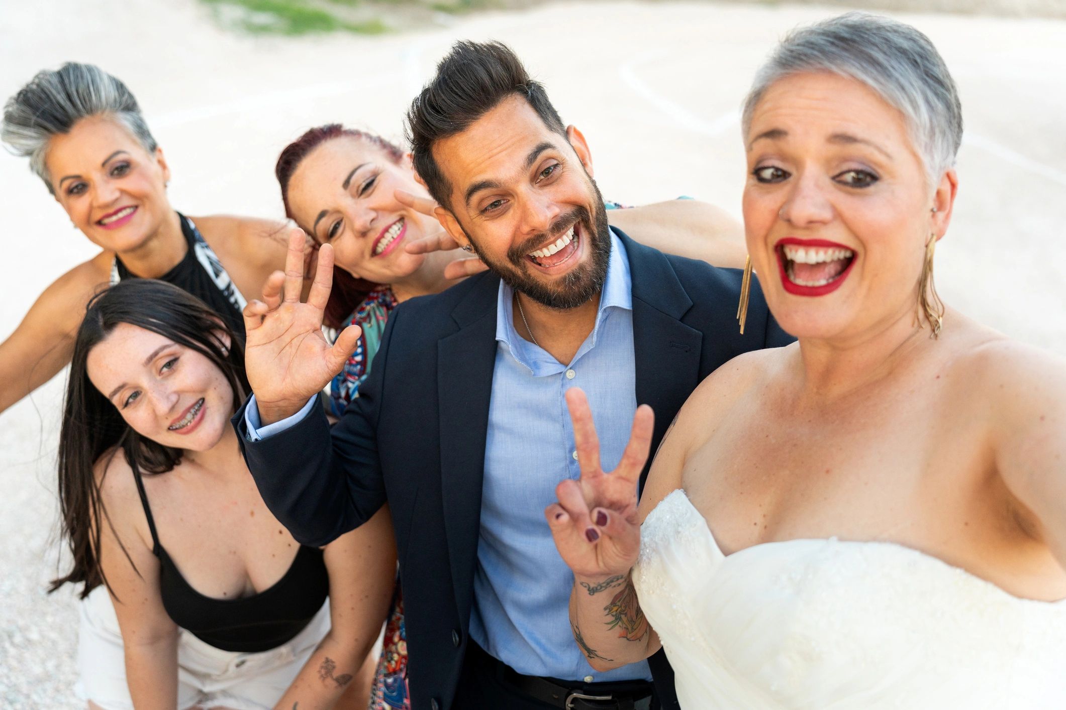Bride and friends taking a fun selfie at a wedding reception