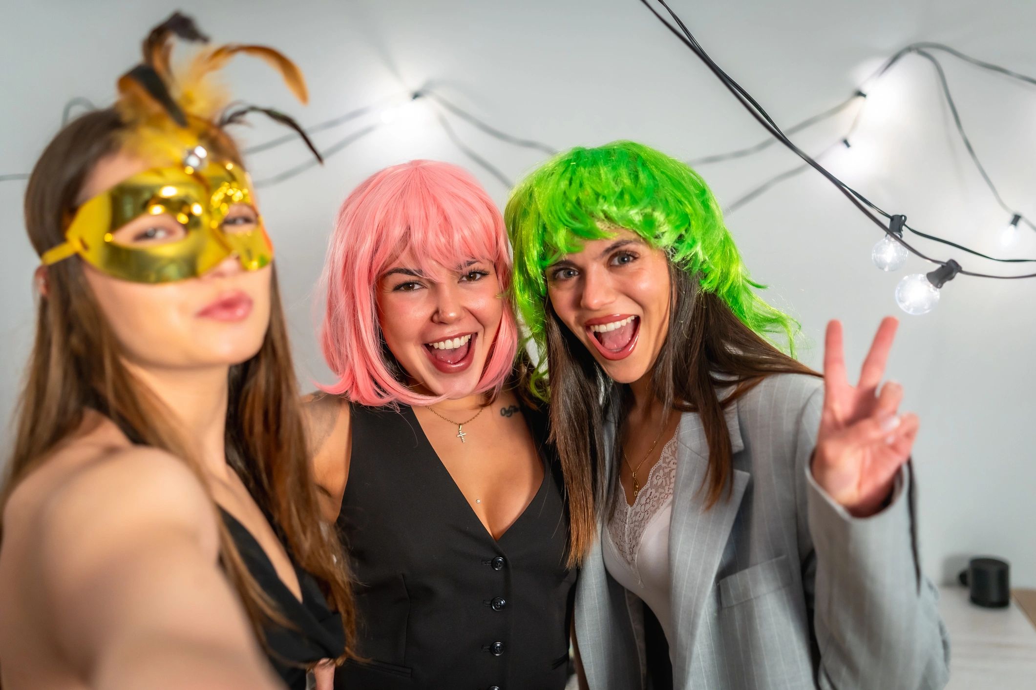 Guests in colorful party attire posing during a lively branded-style celebration